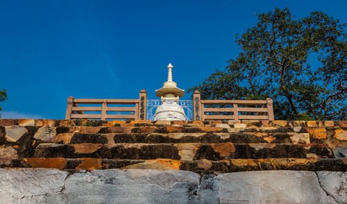 Buddhist stupa isolated with amazing blue sky from unique perspective