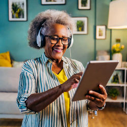 Grandma enjoying the music on her ipad using phone while at home