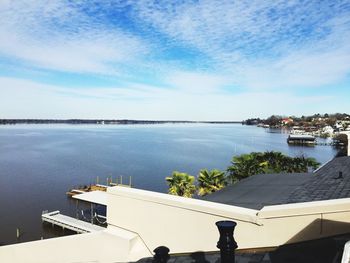 High angle view of buildings by sea against sky