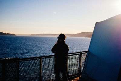 Rear view of woman looking at sea against sky