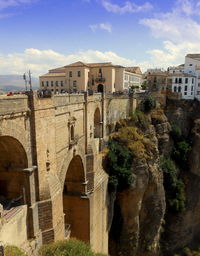 Arch bridge over buildings in city