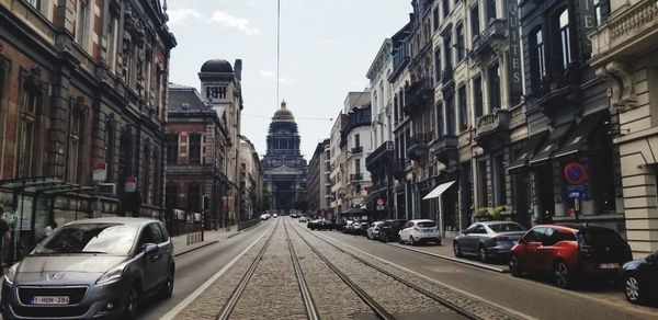 Cars on street amidst buildings in city