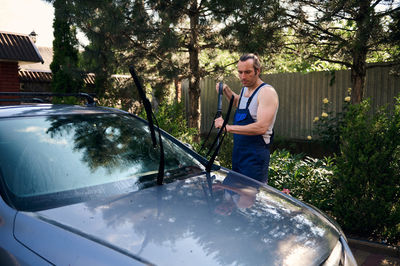 Side view of man sitting in car