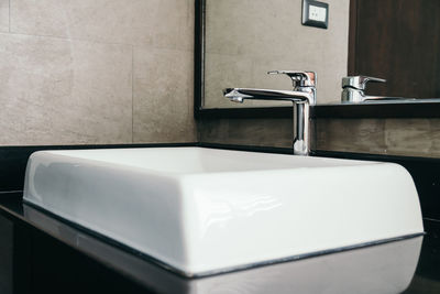 Close-up of faucet in bathroom