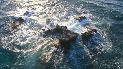 High angle view of rocks in sea