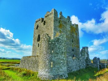 Low angle view of castle against cloudy sky