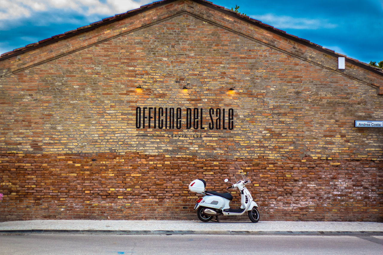 MAN ON STREET AGAINST BUILDING