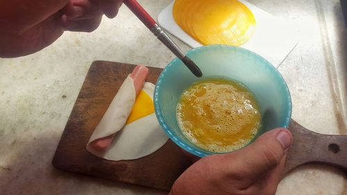 High angle view of person preparing food on table