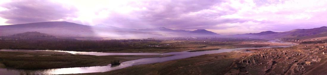 Scenic view of mountains against cloudy sky