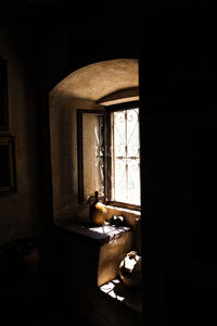 Cat on table in window of abandoned house