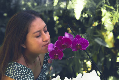 Portrait of woman with pink flower