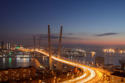 Illuminated cityscape against sky at night