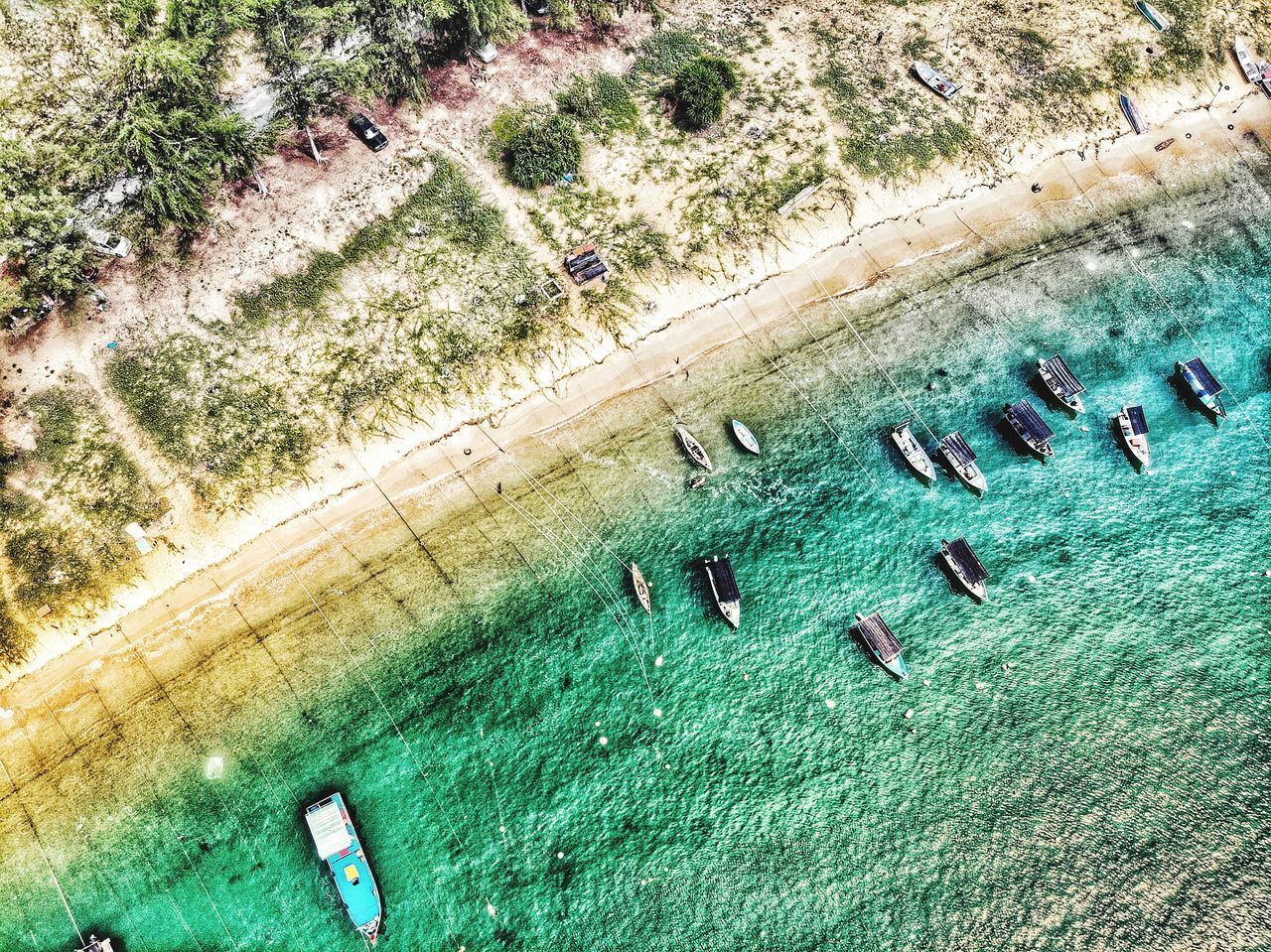 HIGH ANGLE VIEW OF PEOPLE SWIMMING POOL IN SEA