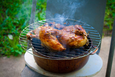 High angle view of chicken wings on barbecue grill