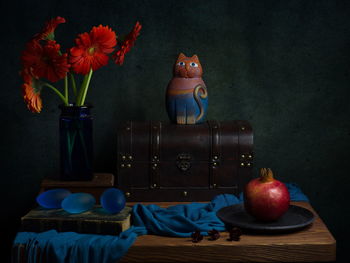 Close-up of various fruits on table against wall