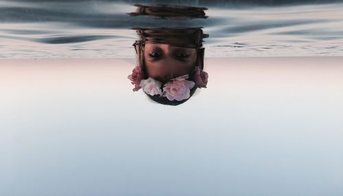 Upside down image of woman in swimming pool