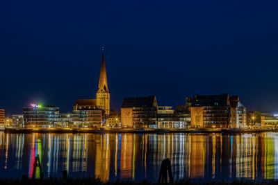 Illuminated buildings in city at night