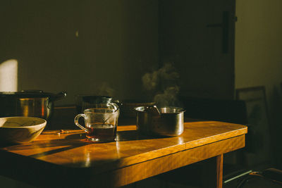 Breakfast with tea cups on the wooden table, early morning with hot food and drink.