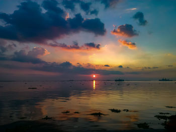 Scenic view of sea against romantic sky at sunset