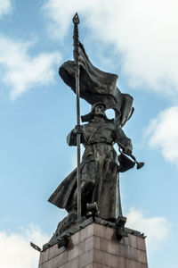 Low angle view of statue against sky