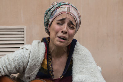 Portrait of beautiful woman singing sad song