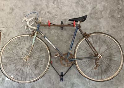 High angle view of bicycle parked against wall