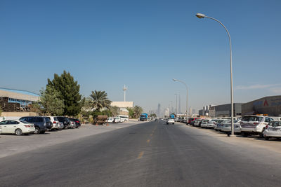 Cars on road against clear sky