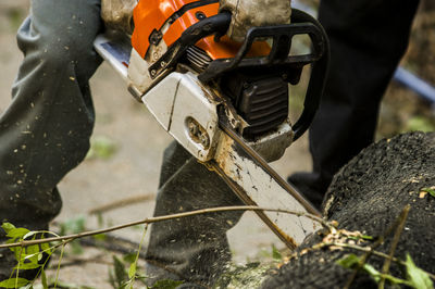 Close-up of using chainsaw