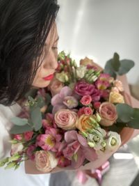 Close-up of rose bouquet and a woman