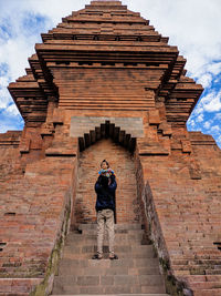 Rear view of man walking on steps