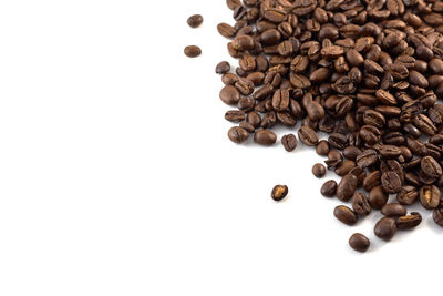 High angle view of coffee beans against white background