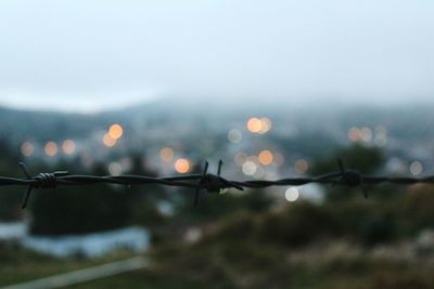 Close-up of raindrops on wet windshield during rainy season