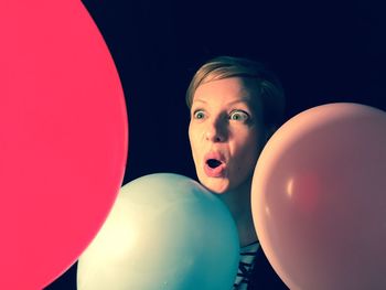 Portrait of young woman with balloons