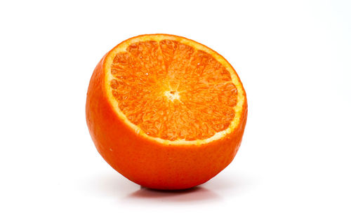 Close-up of orange slice against white background