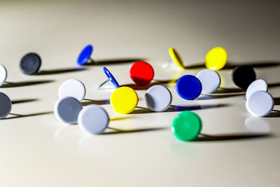 Close-up of thumbtacks over gray background
