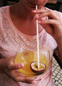 Midsection of woman drinking drink