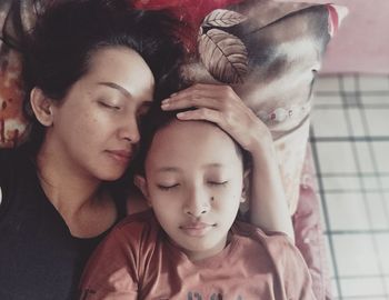 Mother and son sleeping at home