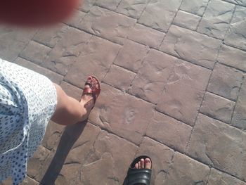 Low section of woman standing on tiled floor