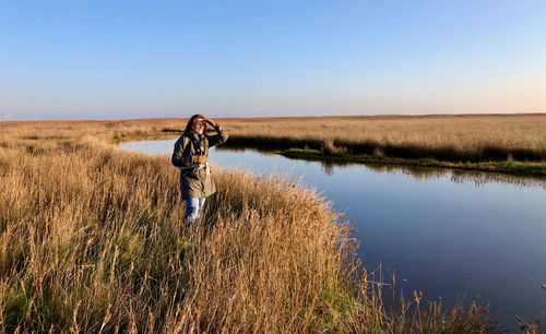 Man standing on land against sky