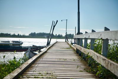 Pier on footbridge against sky