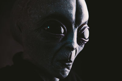 Close-up of alien against black background