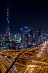 Aerial view of illuminated buildings in city at night