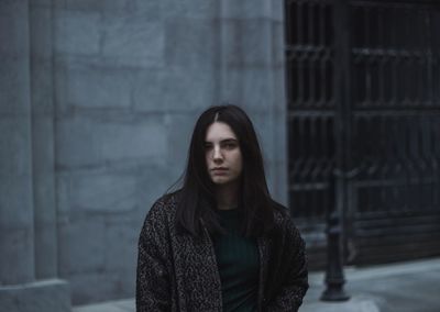 Portrait of woman standing in city