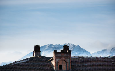 Historic building with snowcapped mountains 