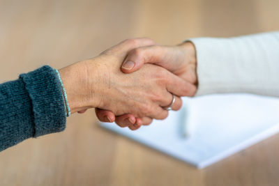 Close-up of hands on table