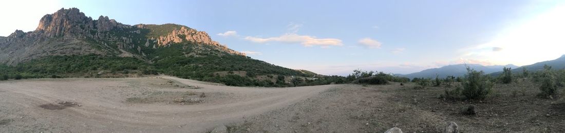 Panoramic view of road amidst mountains against sky