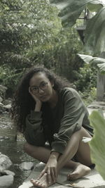 Portrait of a smiling young woman sitting outdoors