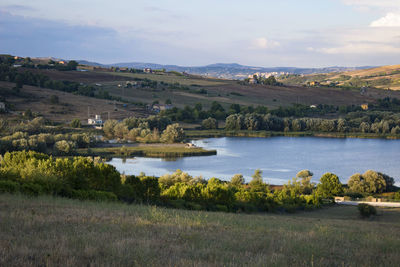 Scenic view of lake and landscape against sky