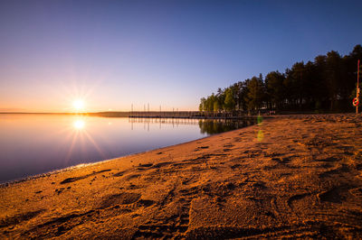 Scenic view of lake at sunset