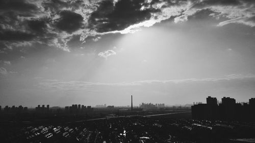 Cityscape against cloudy sky